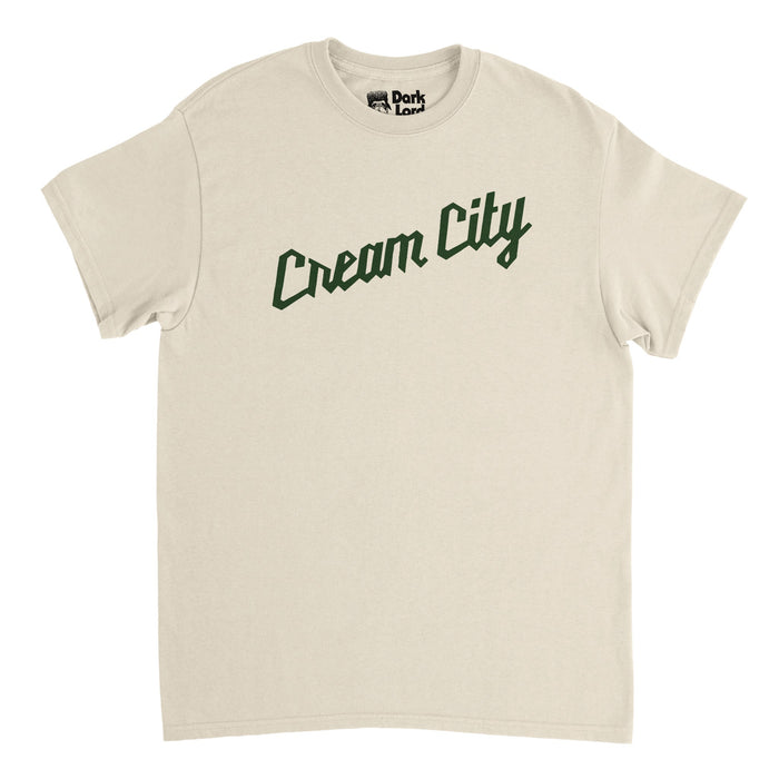 A retro, 80s style soft cream t-shirt that says "Cream City" in dark green text, in reference to the nickname given to Milwaukee, Wisconsin in honor of its light colored bricks made of clay and one of the colors of legendary NBA basketball team the Milwaukee Bucks.