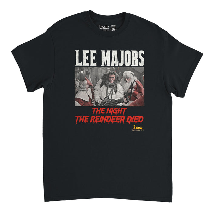 A black retro 80s style short sleeved t-shirt that says "LEE MAJORS" in white text & "The Night The Reindeer Died" & "IBC Yule Love It!" with an image of three people, one dressed like santa with a huge rifle, another wearing a fur white coat with a gun, and an older woman with white hair looking on in shock, surrounded by elves with pointy red hats. References the 1988 comedic film Scrooged, directed by Richard Donner, starring Bill Murray as Frank Cross, Carol Kane, John Forsythe, and Alfre Wo