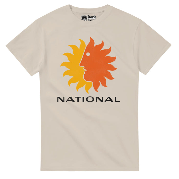 A retro, sand colored off white t-shirt in the 1980s style that says "National" underneath the iconic National Airlines "Sun King" logo, made up of an orange sun looking to the left in a side profile, overlapping a yellow sun, a popular image for the National Airlines company which operated from 1934 until 1980 when it merged with the Pan Am airline company and was mostly headquartered in Miami, famous for its coast to coast to coast flights.