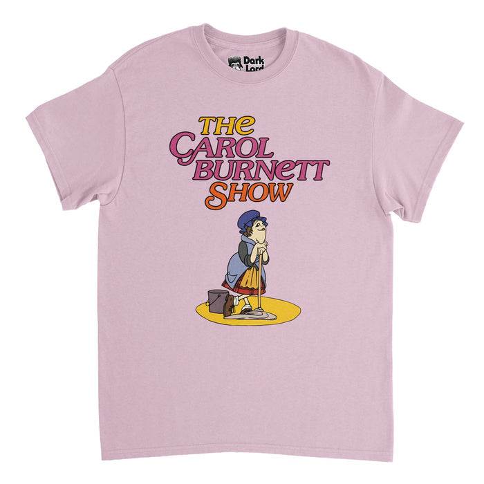 A vintage, short sleeved pink colored t-shirt that says "The Carol Burnett Show" in yellow, pink, and orange bubble letters above a retro image of woman with red curls and a blue maid hat and clothes on a yellow circle leaning on a mop next to a bucket. References the charwoman from the credits of The Carol Burnett Show, a caricature of Carol herself, from the famous television series, also referencing the character Carol Burnett played on The Gary Moore Show.