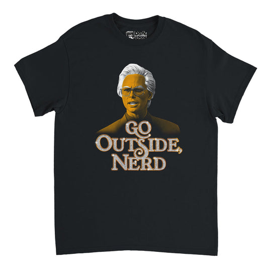 A black colored 80s style short sleeved vintage t-shirt with an image of actor Walton Goggins as character Baby Billy Freeman, his face yellow and hair bright white wearing glasses and a suit above his quote "GO OUTSIDE, NERD" in sparkly white bubble letters. In reference to the crime comedy drama tv series "The Righteous Gemstones" created by Danny McBride that stars Edi Patterson, Danny McBride, John Goodman, Adam DeVine, Cassidy Freeman, and Tony Cavalero.