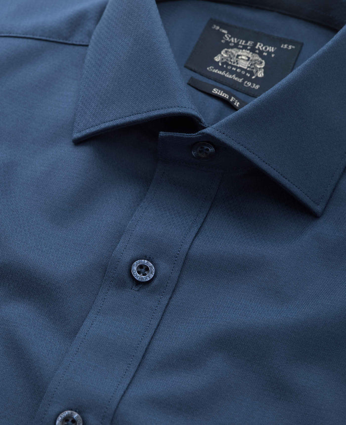 Close-up of a blue shirt with a Savile Row label on the collar.