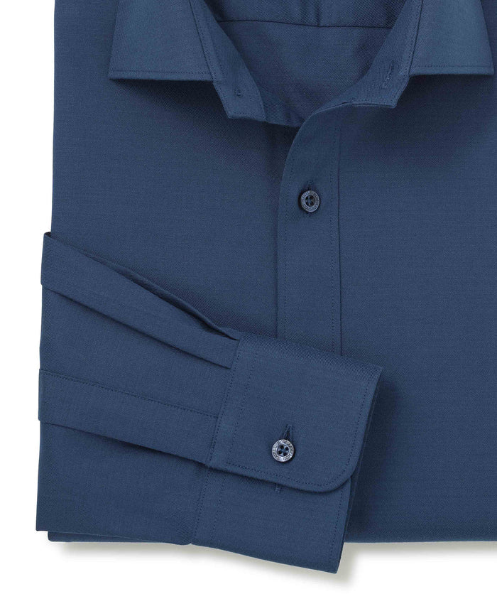 Folded navy shirt with a white background