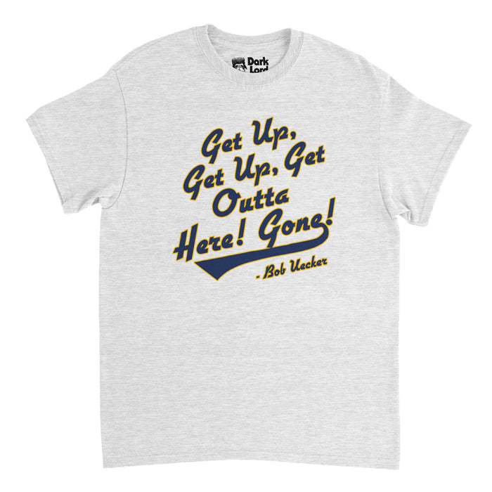 A light, heather gray vintage 80s style t-shirt that says 'Get Up, Get Up, Get Outta Here! Gone!" and "Bob Ueker" in gold and navy colors, the same as the team colors of the Milwaukee Brewers MLB team. In reference to the famous catchphrase Ueker would shout every time while announcing a Brewers game when a baseball player hit a home run.