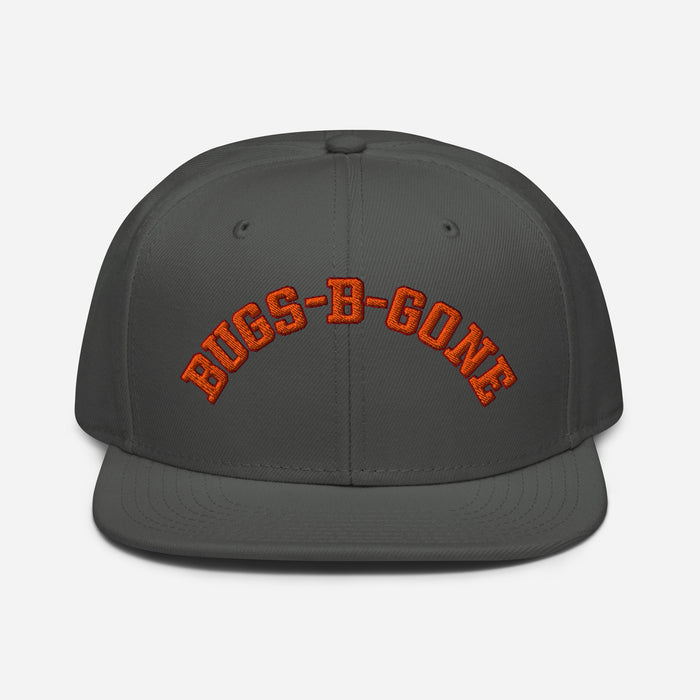 A charcoal gray colored retro, souvenir costume hat that says "BUGS-B-GONE" in orange text, referencing the extermination business that character Delbert McClintock - played by famous actor John Goodman - runs in the comedy horror thriller movie "Arachnophobia" from 1990, directed by Frank Marshall.