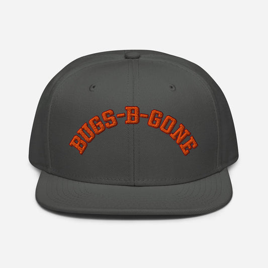 A charcoal gray colored retro, souvenir costume hat that says "BUGS-B-GONE" in orange text, referencing the extermination business that character Delbert McClintock - played by famous actor John Goodman - runs in the comedy horror thriller movie "Arachnophobia" from 1990, directed by Frank Marshall.