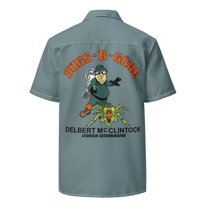 A retro, sea green / gray collared costume button up short sleeved shirt, the back of which says "BUGS-B-GONE" in bright orange bubble letters above the image of a man in a green outfit, glasses, and a hat with a white contraption on his back pointing it at a green and orange large spider. Also says "Delbert McClintock, Licensed Exterminator", referencing the character from the 1990 horror comedy film "Arachnophobia" which starred John Goodman as the exterminator character.