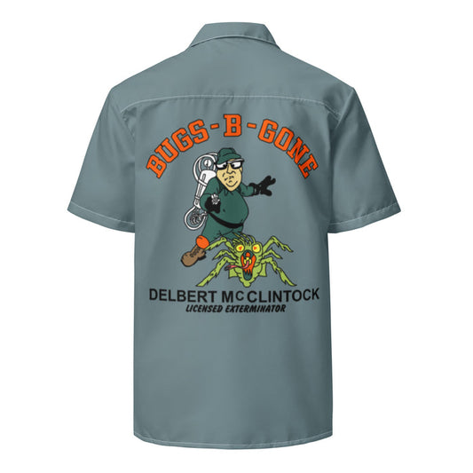 A retro, sea green / gray collared costume button up short sleeved shirt, the back of which says "BUGS-B-GONE" in bright orange bubble letters above the image of a man in a green outfit, glasses, and a hat with a white contraption on his back pointing it at a green and orange large spider. Also says "Delbert McClintock, Licensed Exterminator", referencing the character from the 1990 horror comedy film "Arachnophobia" which starred John Goodman as the exterminator character.