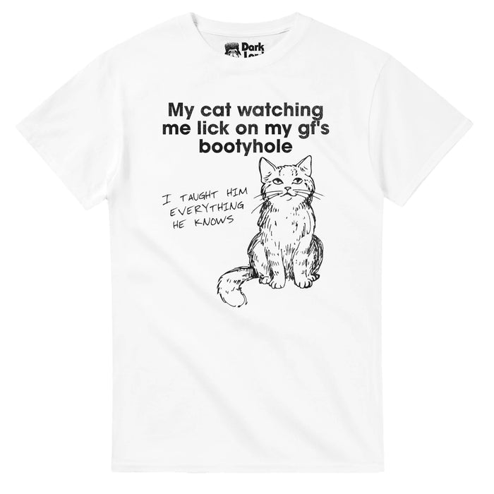 A white colored vintage, funny cat pun souvenir t-shirt that says "My cat watching me lick on my gf's bootyhole" (referencing girlfriend,) and the cat thinking "I taught him everything he knows" with an image of a cat sitting with long whiskers, looking up as if knowledgable.