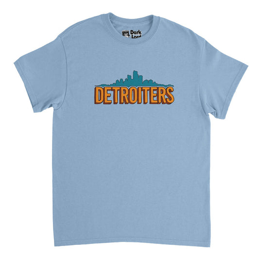 A retro, souvenir blue colored t-shirt that says "DETROITERS" in orange bubble letters with an image of the Detroit skyline filled in with aqua blue. References the hilarious American sitcom television show 'Detroiters' starring Tim Robinson and Sam Richardson.