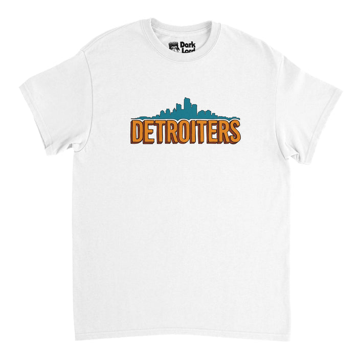 A vintage, 80s style white colored t-shirt that with an image of the Detroit city skyline in a bright turquoise blue color above the word "Detroiters" all in bold, capitalized orange bubble letters. References the iconic sitcom TV series "Detroiters", created by Sam Richardson, Zach Kanin, Tim Robinson, and Joe Kelly, taking place in Detroit, Michigan.