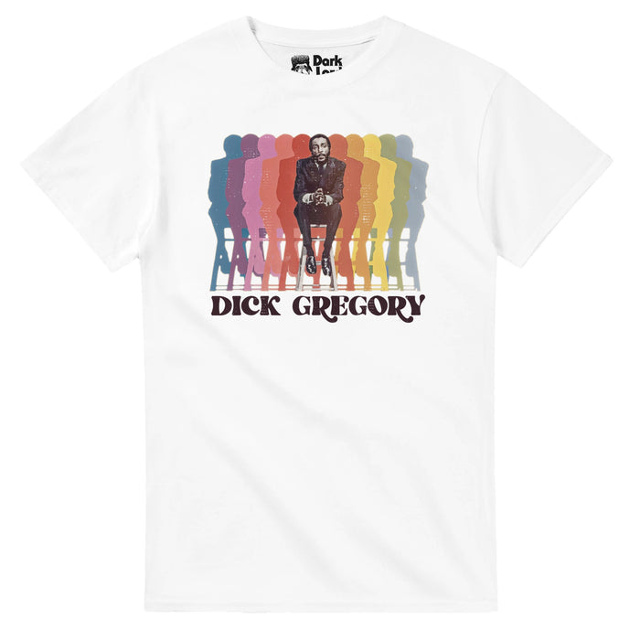 A retro, 80s style white colored t-shirt that says Dick Gregory underneath a black and white image of the iconic comedian and actor next to many of his reflections in various colors, from pink to yellow to green to blue. In reference to the comedian, Richard Claxton Gregory, also an activist and social critic, famous for his "no holds barred" sets, fighting against racism and bigotry through his iconic comedy, also an activist against the Vietnam War, and for racial justice, animal rights, and f