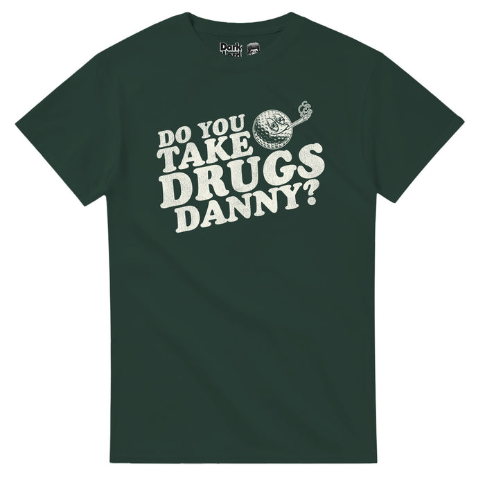 A retro, forest green colored 80s style short sleeved t-shirt that says in bold white text "Do you take drugs Danny? beside an graphic of a golf ball smoking a joint, likely of weed, eyes half closed, a smile on its face. References the 1980 sports comedy film "Caddyshack" about golfing, starring Bill Murray as Carl Spackler, and the quote that character Ty Webb (played by Chevy Chase) says to character Danny Noonan (played by Michael O'Keefe).