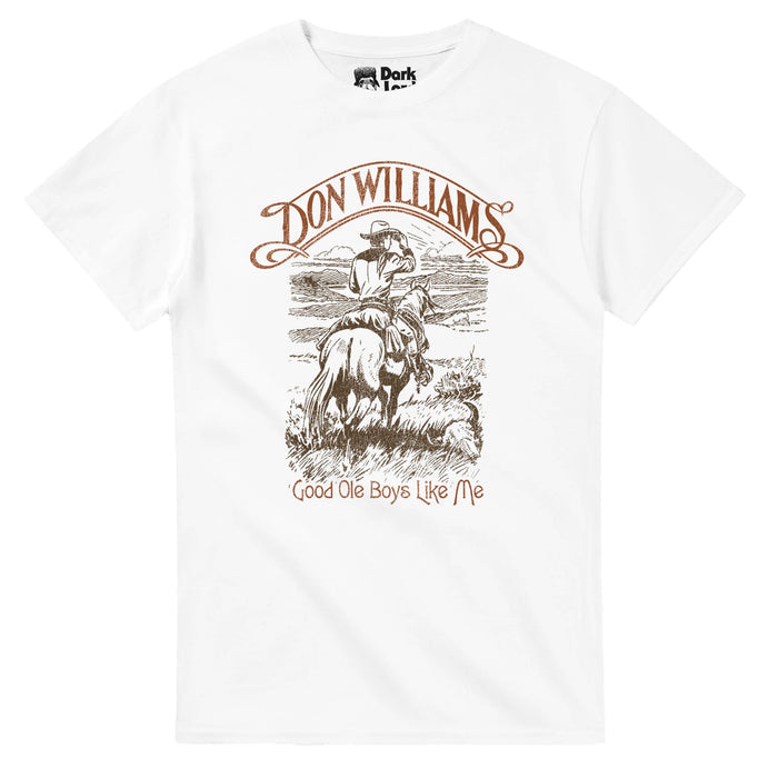 A vintage, 80s style souvenir white colored t-shirt that says Don Williams and Good Ole Boys Like Me around an image of a man riding on a horse dressed in cowboy clothing with a cowboy hat, tipping his hat to someone in the distance, in the grasslands with the sun in the distance. References the famous country singer Don Williams who sang the song "Good Ole Boys Like Me", written by Bob McDill, released in his album "Portrait", popular in the 1980s.