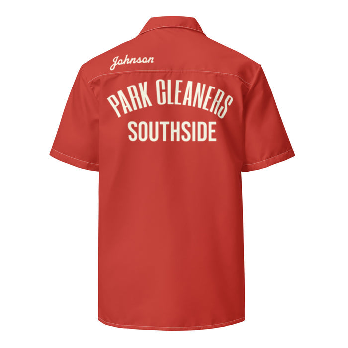 The back of a bright orange-red collared costume retro shirt that says "PARK CLEANERS SOUTHSIDE" in bold white letters and the name "Johnson" in cursive. References the bowling outfit that the character Donny, played by legendary actor Steve Buscemi, in the comedy film "The Big Lebowski".