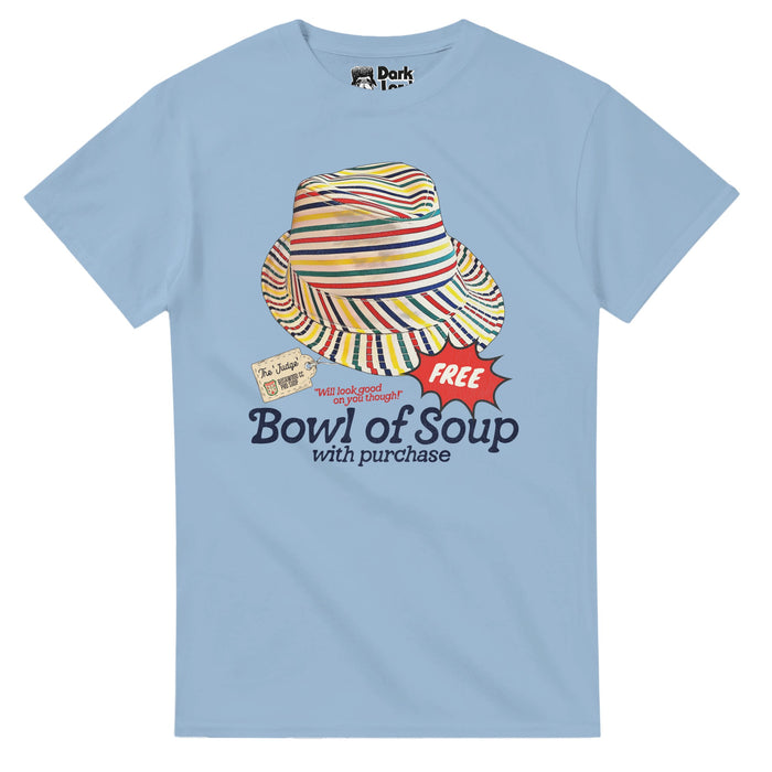 A retro, light blue 80s style t-shirt saying "Bowl of Soup with purchase" & "Will look good on you though!" with a striped red, yellow, red, & navy blue hat with a tag that says "The 'Judge'" and a spiky speech balloon that says "FREE". References the Al Czervik (Rodney Dangerfield) quote "Oh, this is the worst looking hat I ever saw. What, when you buy a hat like this I bet you get a free bowl of soup, huh?" from the 1980 movie Caddyshack, starring Chevy Chase, Ted Knight, Michael O'Keefe, & Bi