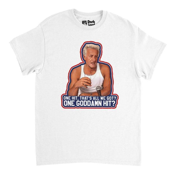 A vintage, souvenir white t-shirt with the image of Bob Ueker holding a glass and speaking into a microphone with the quote "One hit, that's all we got? One goddamn hit?", outlined in blue, red, and white, the colors of MLB baseball. References the famous quote Harry Doyle, played by legendary Milwaukee Brewer's baseball announcer Bob Ueker, in the 1989 comedy sports film "Major League".