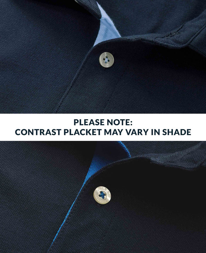 Close-up of a navy shirt with a button and contrasting placket, with text indicating color variation.
