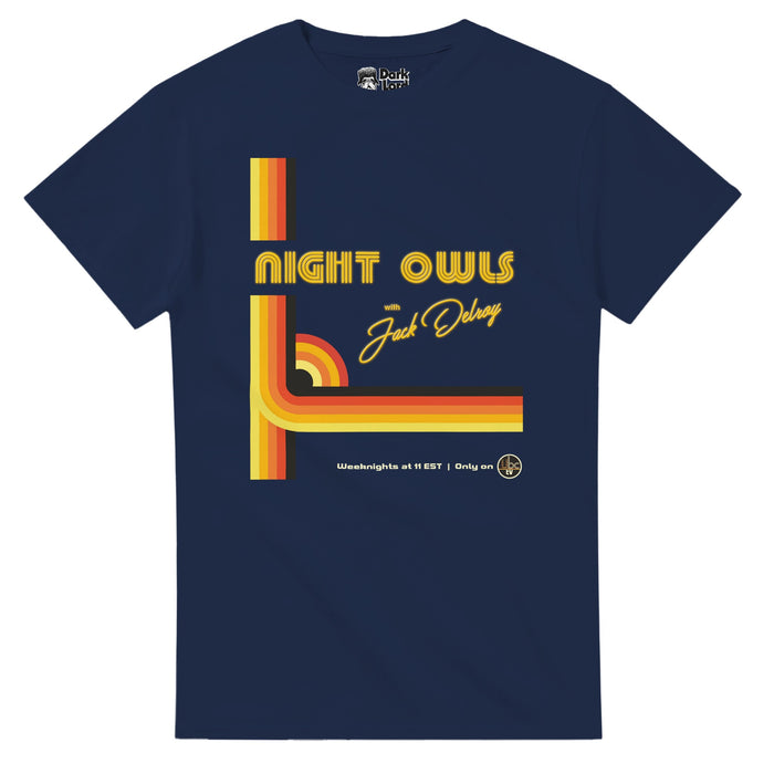 A retro, navy blue colored short sleeved 80s style t-shirt that says "Night Owls with Jack Delroy" in yellow text and "Weeknights at 11 EST, Only on UBC TV" with black/orange/yellow stripes across the shirt with a small quarter circle rainbow section of stripes. References the 2023 indie horror film 'Late Night With The Devil' and Jack Delroy's (David Dastmalchian) television late-night broadcast from the 1970s, specifically Halloween of 1977, and is in competition with Johnny Carson's The Tonig