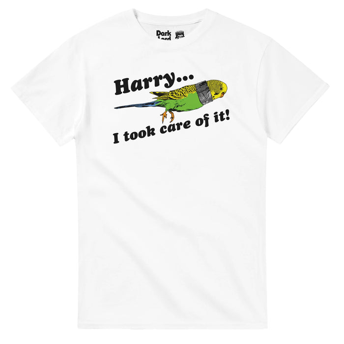 A retro, vintage 70s style white colored t-shirt that says "Harry... I took care of it!" referencing the iconic quote spoken by actor Jim Carrey as Lloyd Christmas to actor Jeff Daniels as Harry Dune in the screwball comedy film 'Dumb and Dumber'. The shirt includes an image of a small yellow and green bird with orange feet and a piece of tape around its neck, a reference to the decapitated bird that Lloyd taped together in the movie.