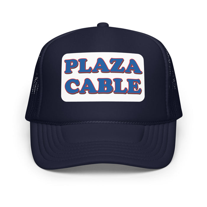 A vintage, souvenir navy colored foam trucker hat that says "Plaza Cable" in blue letters surrounded by the color red on a white background. In reference to the hilarious sitcom TV show 'Seinfeld' and the character Kramer, played by Michael Richards, who runs away from a truck with the Plaza Cable logo and the Cable Guy, played by Walter Olkewicz, wearing the iconic Plaza Cable hat.