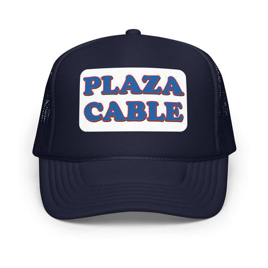 A vintage, souvenir navy colored foam trucker hat that says "Plaza Cable" in blue letters surrounded by the color red on a white background. In reference to the hilarious sitcom TV show 'Seinfeld' and the character Kramer, played by Michael Richards, who runs away from a truck with the Plaza Cable logo and the Cable Guy, played by Walter Olkewicz, wearing the iconic Plaza Cable hat.