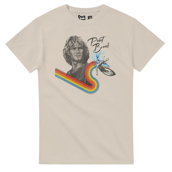 A retro, sand colored vintage short sleeved t-shirt that says Point Break with a black and white image of the character Bodhi with blonde wavy hair, a four colored rainbow of red, orange, yellow, and blue underneath representing the path of a surfer, with a small black and white surfer on a checkered surfboard, waves splashing behind. References the 1991 action thriller film "Point Break", directed by Kathryn Bigelow, starring Keanu Reeves as Johnny Utah and Patrick Swayze as Bodhi.