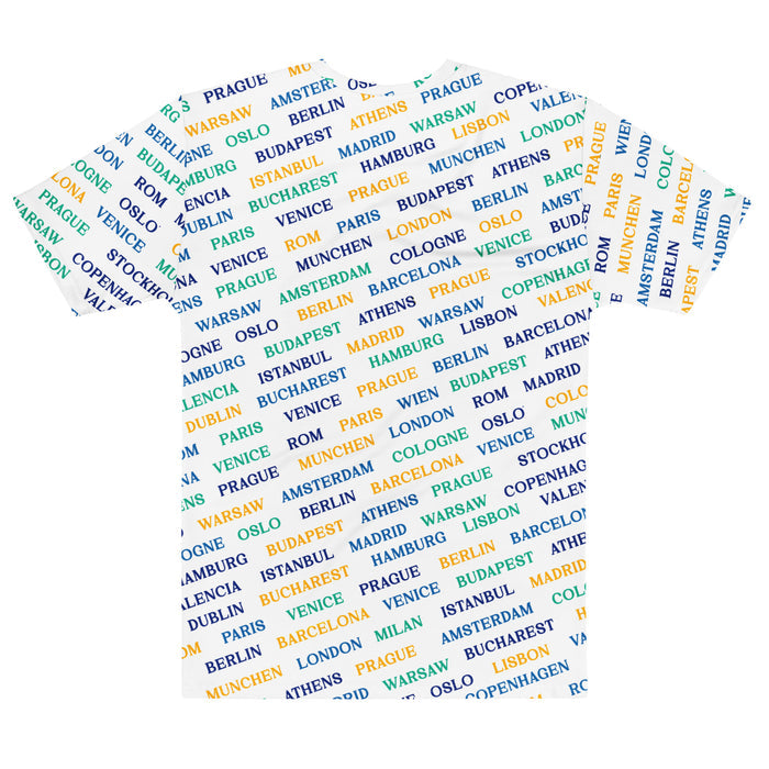 The back of a white colored, retro 80s style t-shirt with all over print in yellow, green, navy, black, and blue with names of various European cities popular for tourists, travelers, and adventurers including Warsaw, Amsterdam, Prague, Budapest, Athens, Munchen, London, Berlin, Barcelona, Cologne, Oslo, Venice, Buharest, Istanbul, Copenhagen, Rom, Madrid, Lisbon, and Milan.