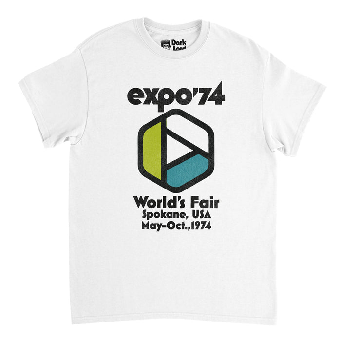 A vintage, souvenir Word's Fair 1974 t-shirt in the color white. Says Expo '74, World's Fair, Spokane, USA, May-Oct., 1974 with the logo of a tricolored Möbius symbol in colors white, green, and blue, representative of the clean water, clear sky, and plants, similar to the recicyling symbol, representative of the Spokane Expo's theme of environmental protection.