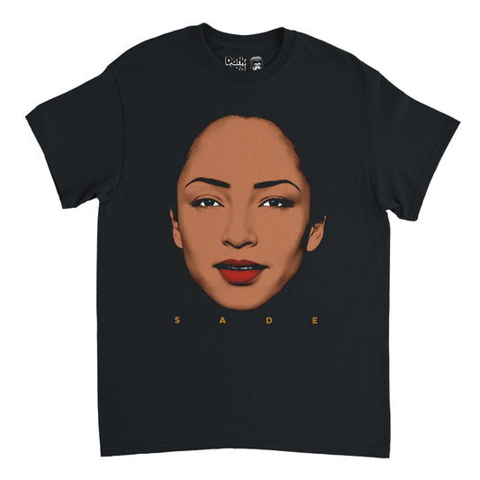 A vintage, 70s style t-shirt in the color black that says "SADE" underneath an image of the lead singer, Sade Adu, with bright red lipstick looking straight at you. References the singer and songwriter, one of the most successful female artists from Britain ever, as well as the band with the same name, Sade, also including Paul Denman, Stuart Matthewman, and Andrew Hale, with hits like "Smooth Operator", "By Your Side", "No Ordinary Love", "Cherish the Day", "Like a Tattoo", and "Is It a Crime".