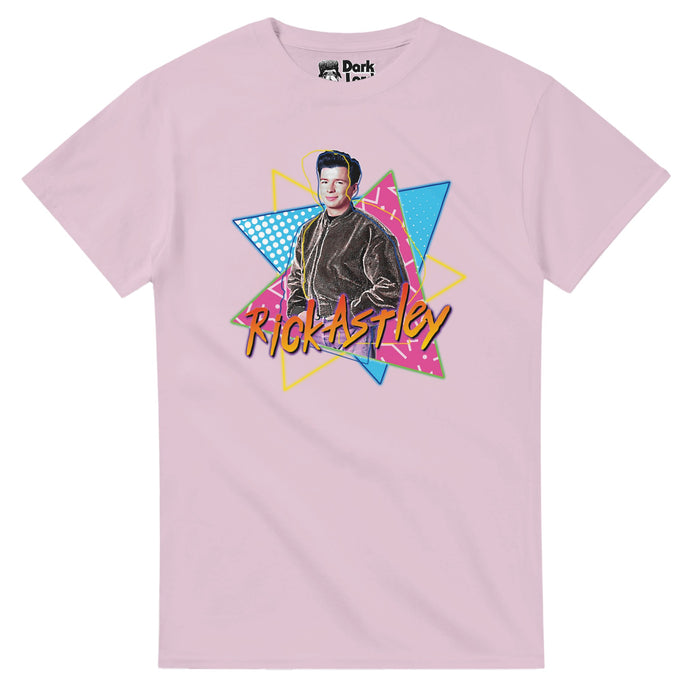 A vintage, light pink 70s style t-shirt that says "Rick Astley" in hombre pink, orange, and yellow letters with an image of the young singer against three colorful, pattern filled yellow, blue, and pink triangles. In reference to Richard Paul Astley, the famous English singer, songwriter, radio DJ and podcaster, known worldwide for his 1987 chart topping hit "Never Gonna Give You Up" as well as "Together Forever", "Cry for Help", "Take Me to Your Heart", "Hold Me in Your Arms", and "Never Gonna