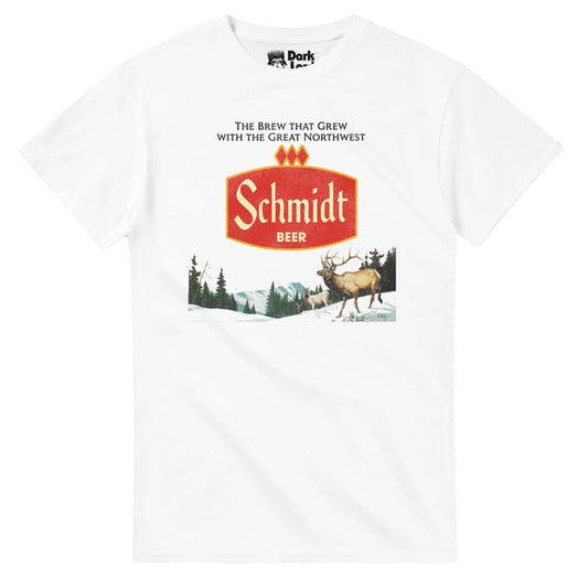 A white colored, retro souvenir t-shirt that says "The Brew That Grew with the Great Northwest" above an image of the red logo for Schmidt Beer and an image of the wilderness complete with multiple deer, one with huge antlers, mountains, snow, and pine tree forests. References the macro lager started in Minnesota, sold from 1860-1987, known as the "Official beer of the American sportsman", the brand eventually sold to Pabst.