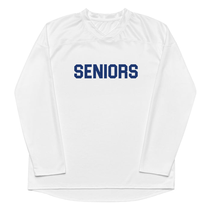The front of a white colored vintage, 80s style hockey fan jersey and costume with the word "SENIORS" on the front in navy blue, all letters capitalized. In reference to the shirt popular character Darla Marks wears while hazing high schoolers with squirting ketchup bottles in the iconic comedy indie coming of age movie 'Dazed and Confused'.
