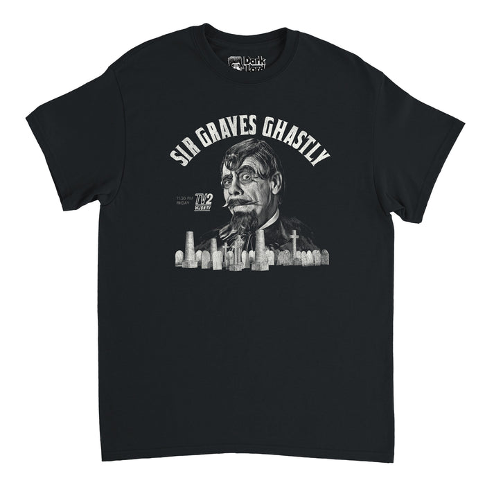 A retro, 80s style black t-shirt that says "Sir Grave Ghastly" and "11:30 PM Friday" and "TV2 WJBK-TV", a TV station. Has the graphic of a graveyard filled with different size and shape graves including crosses, and the image of ghostly character Sir Graves Ghastly, created by actor Lawson J Deming for the horror TV series also called "Sir Graves Ghastly".