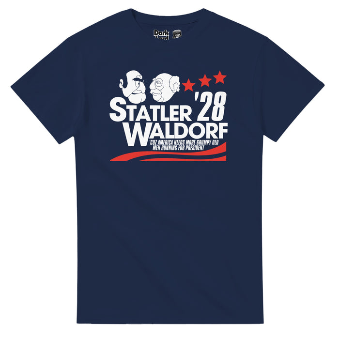 A retro, navy blue colored short sleeved 80 style t-shirt that says "Statler Waldorf '28, 'Cuz America Needs More Grumpy Old Men Running For President" with an image of the two muppets drawn white, looking at each other, and red colored graphics of three stars and wavy lines like one sees in campaign materials. References the two always bickering muppets on "The Muppet Show" played by multiple actors including Richard Hunt, Adam Hunt, Jim Henson, Steve Whitmire, and Matt Vogel.