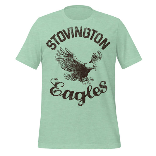 A mint green colored retro, 70s style t-shirt that says "Stovington Eagles" with the image of an American bald eagle at the center. References the iconic horror film "The Shining" based on the Stephen King novel, in which character Jack Torrance, played by Jack Nicholson, wears this shirt due to his old days teaching at Stovington Preparatory School in Vermont.