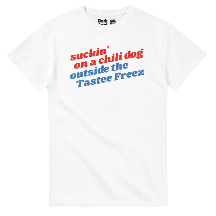 A retro, red white and blue 80s style t-shirt with the background color white that says "suckin' on a chili dog outside the Tastee Freez" in reference to the #1 chart-topper song and music video "Jack and Diane" from 1982 by singer and songwrite John 'Cougar' Mellencamp in which Diane sits on Jack's lap, a fresh chili dog in her hand.