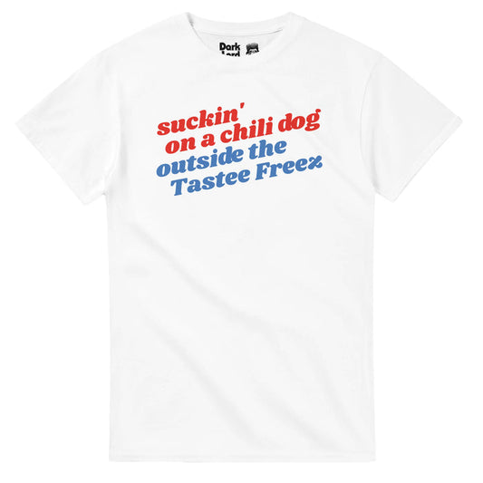 A retro, red white and blue 80s style t-shirt with the background color white that says "suckin' on a chili dog outside the Tastee Freez" in reference to the #1 chart-topper song and music video "Jack and Diane" from 1982 by singer and songwrite John 'Cougar' Mellencamp in which Diane sits on Jack's lap, a fresh chili dog in her hand.