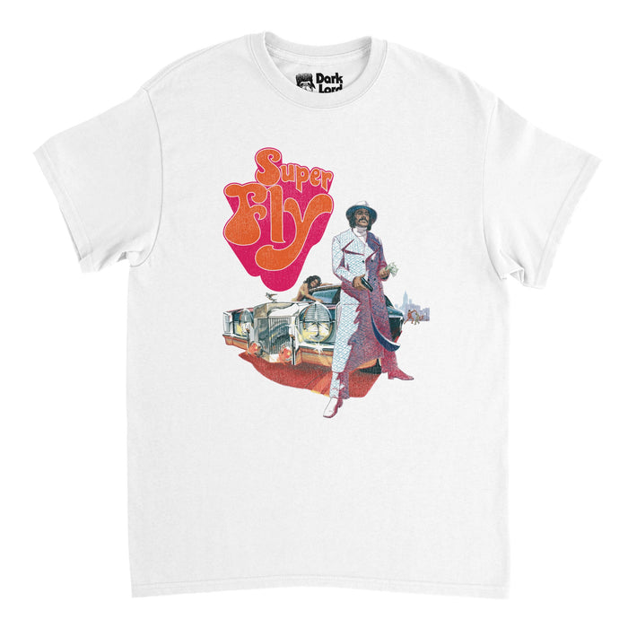 A retro, 90s style t-shirt in the color why that says "Super Fly" in orange and red bubble letters with the image of actor, director, and screenwriter Ron O'Neal as Youngbood Priest front and center in a gray overcoat in front of a vintage custom Cadillac Eldorado "pimpmobile" car, a woman laying on top, in reference to the film poster of "Super Fy" from 1972, a blaxploitation crime drama movie directed by Gordon Parks Jr.