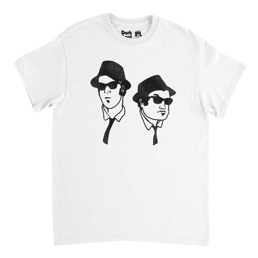 A retro, white colored 80s style t-shirt with short sleeves with the graphic of two men wearing black hats, sunglasses, and ties, drawn onto the shirt. References the iconic 1980 musical action comedy film "The Blues Brothers" directed by John Landis and starring Jake, played by John Belushi, and Elwood, playbed by Dan Aykroyd.