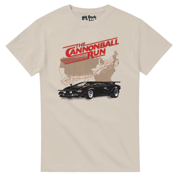A sand colored 70s style t-shirt that says "The Cannonball Run" in red text with red lines, a graphic map of the United States with a red trail marked from Connecticut to California, and a black Lamborghini car. References the comedic action movie The Cannonball Run, popular in the 1980s, about the outlaw cross country road race called Cannonball Baker Sea-To-Shining-Sea Memorial Trophy Dash, with famous actors like Jacki Chan, Farrah Fawcett, Dom DeLuise, Burt Reyolds, and Roger More.