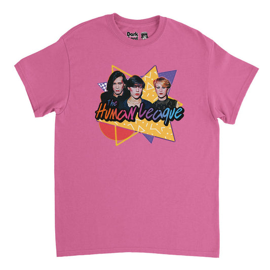 A retro, 70s style pink t-shirt with triangular and circular yellow and purple shapes overlapping each other, filled with various patterns, with band members Philip Oakey, Joanne Catherall, and Susan Ann Sulley shown with dark makeup and clothing under "The Human League", written in purple, orange, blue, & pink colors in reference to the English synth band from Sheffield which became famous from the album "Dare" and had hits like "Don't You Want Me", "Human", "Open Your Heart", & "The Sound of t